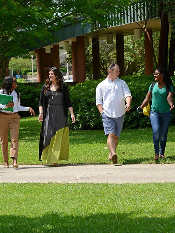 Students walk across the main campus in Pensacola.